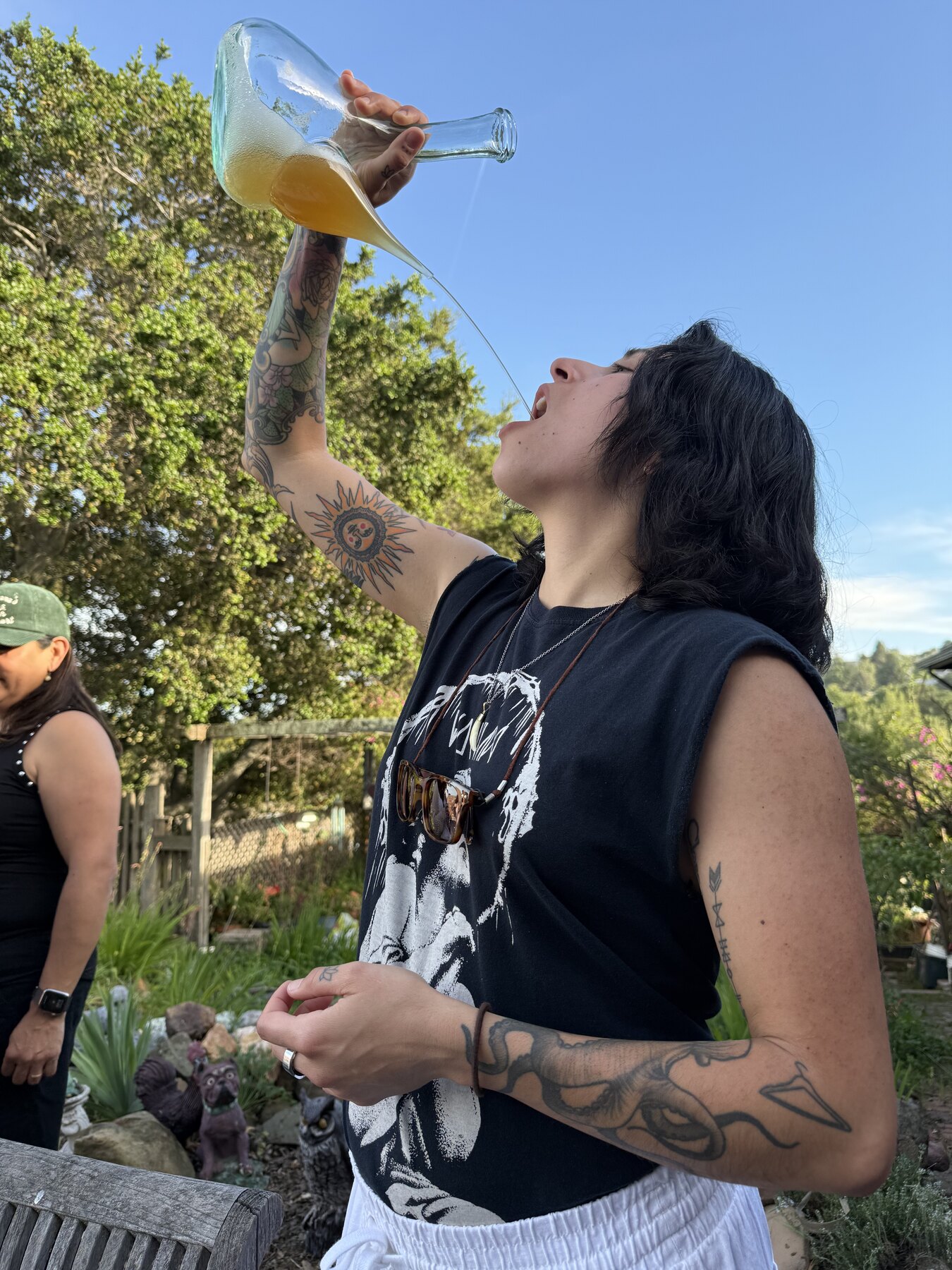 A guest taking a playful drink outdoors